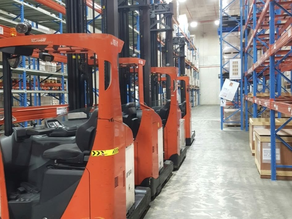 Toyota reach trucks lined up in a warehouse aisle