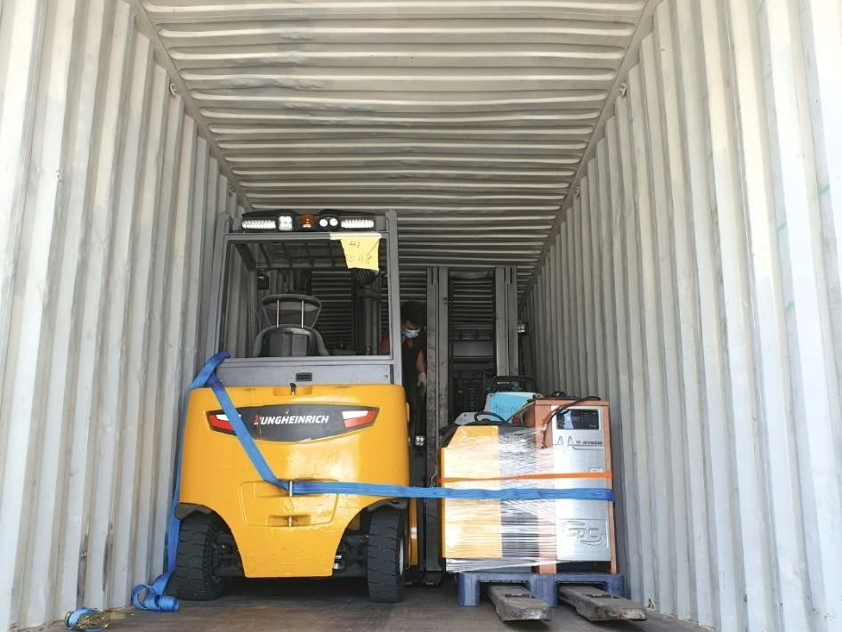 Jungheinrich forklift strapped inside a container