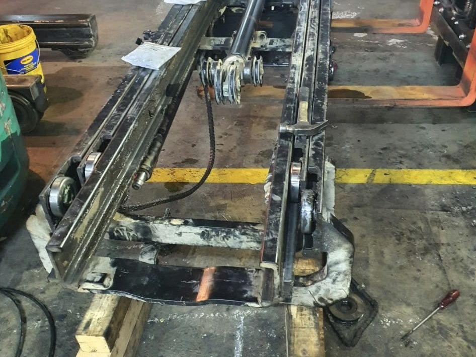 Forklift mast rails on the workshop floor