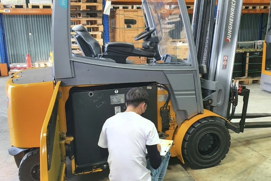 Technician servicing a forklift